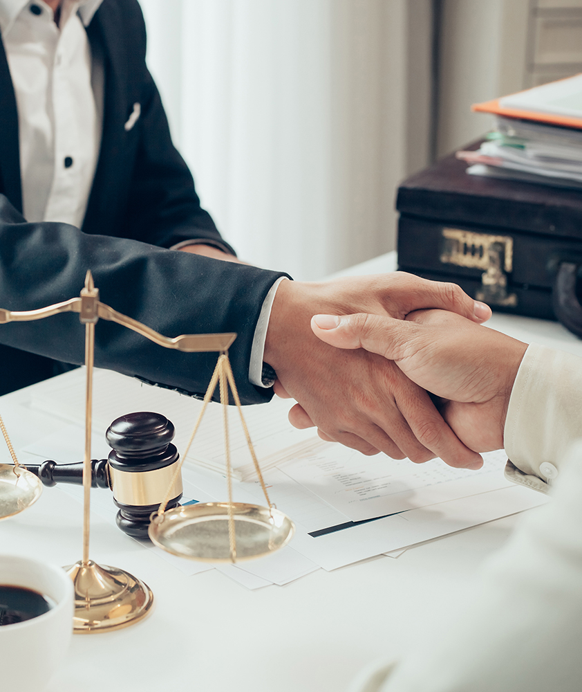 Two men shaking hands in a law office